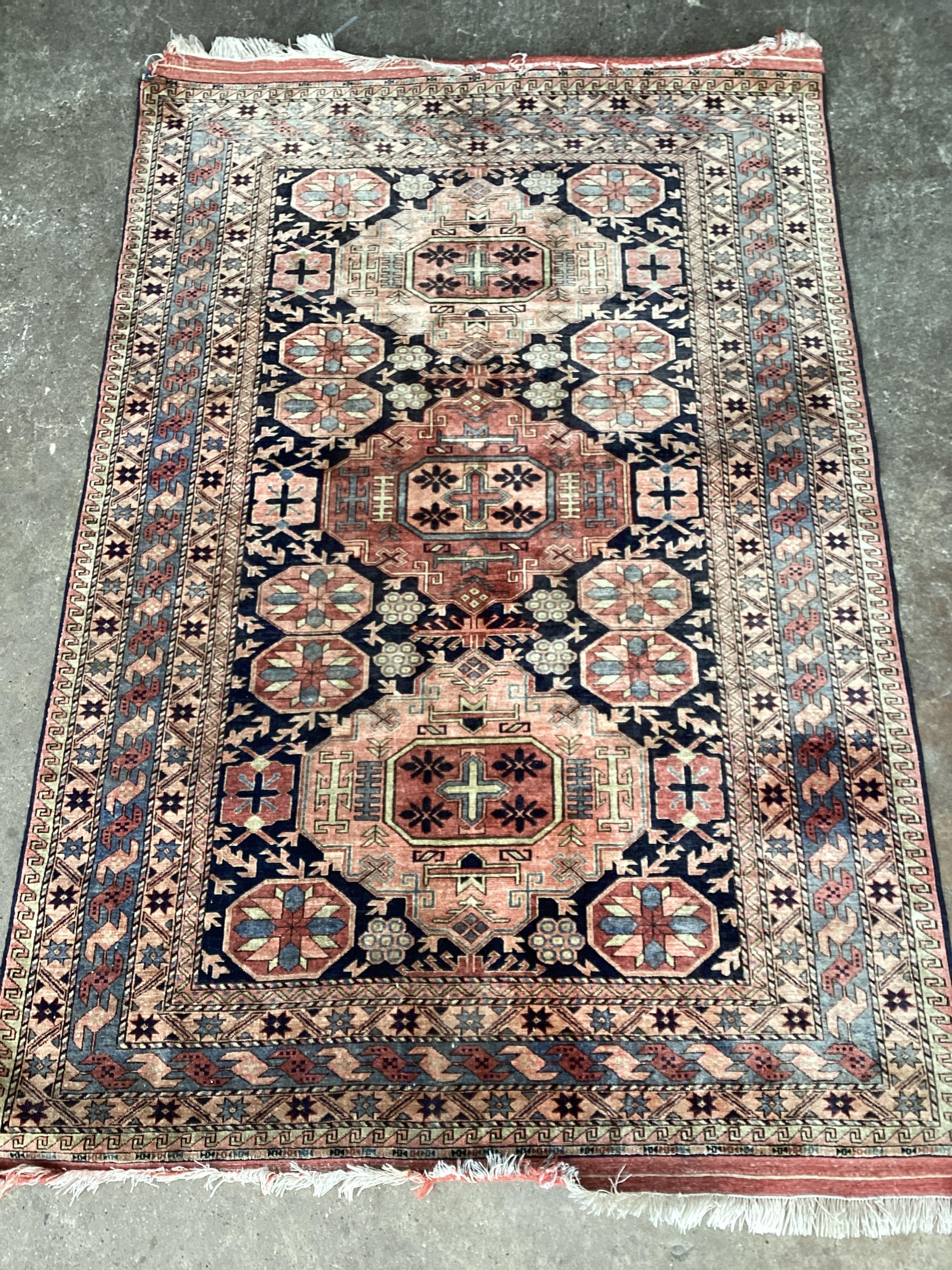 A Hamadan pink ground rug, the centre woven with a row of oval medallions, 185 x 70cms